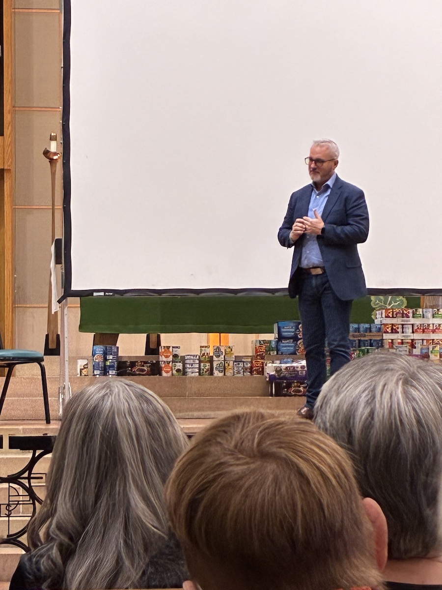 Scott Bottoms standing on the stage area after speaking.